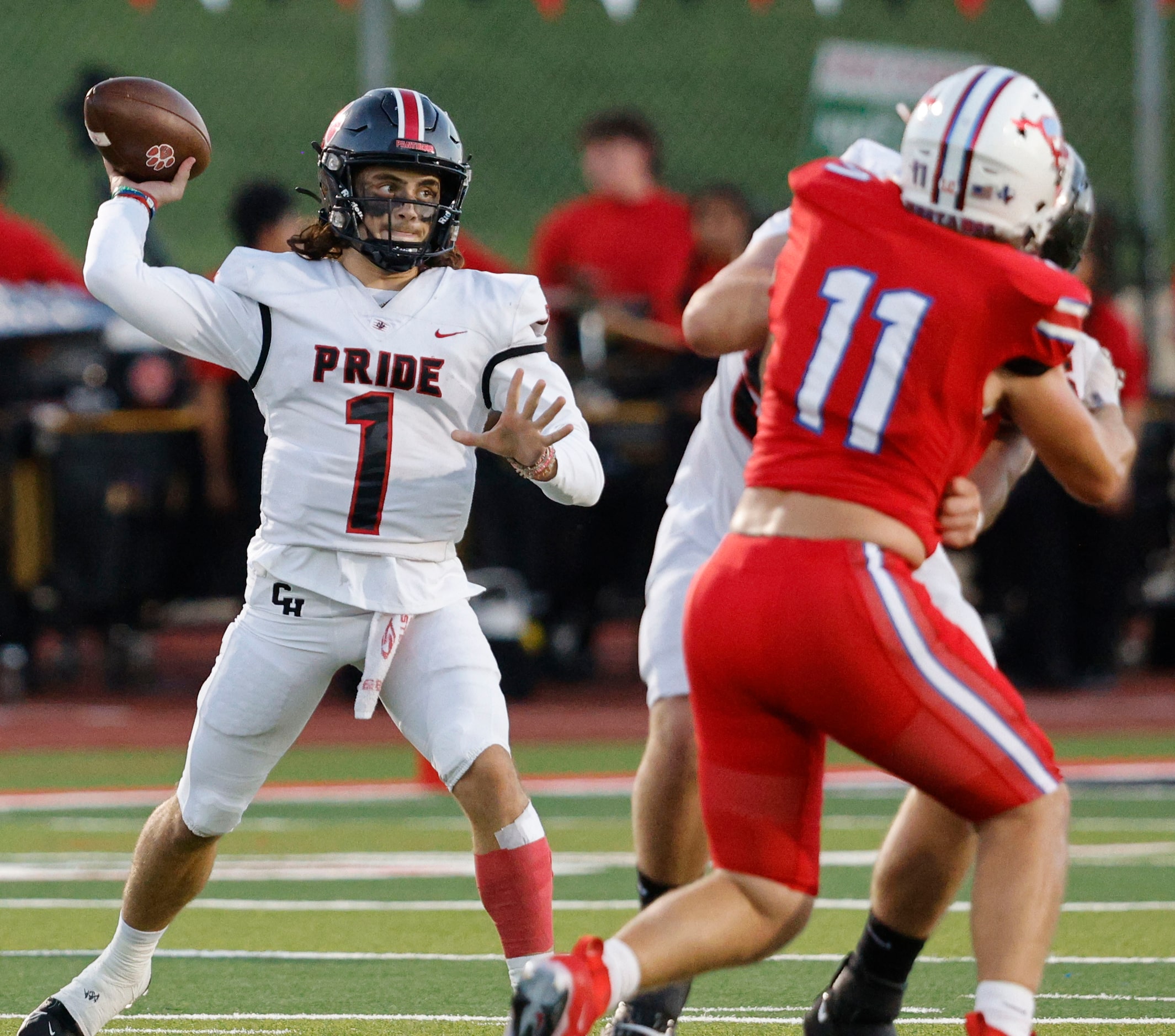 Colleyville Heritage's quarterback Luke Ullrich (1) passes under pressure from Grapevine's...