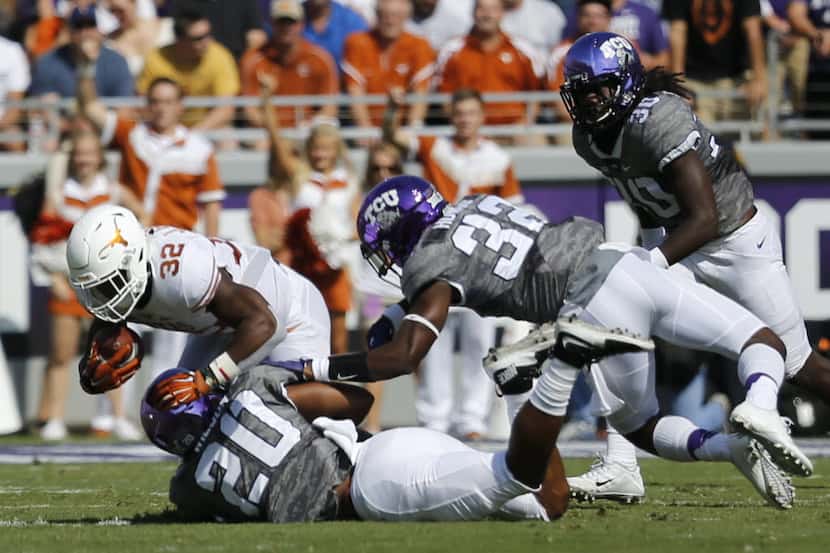 Texas Longhorns running back Johnathan Gray (32) is tackled by TCU Horned Frogs linebacker...