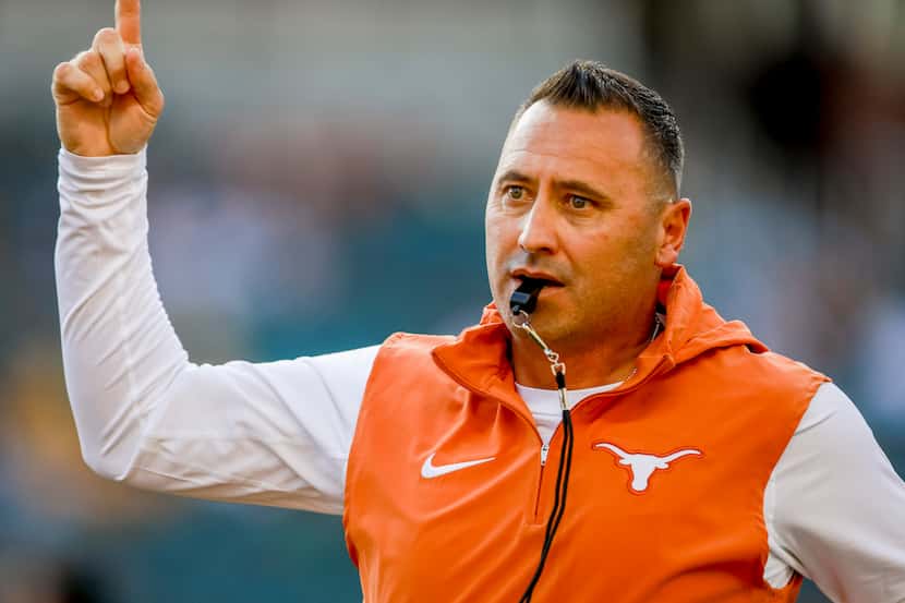 Texas coach Steve Sarkisian talks to players before an NCAA college football game against...