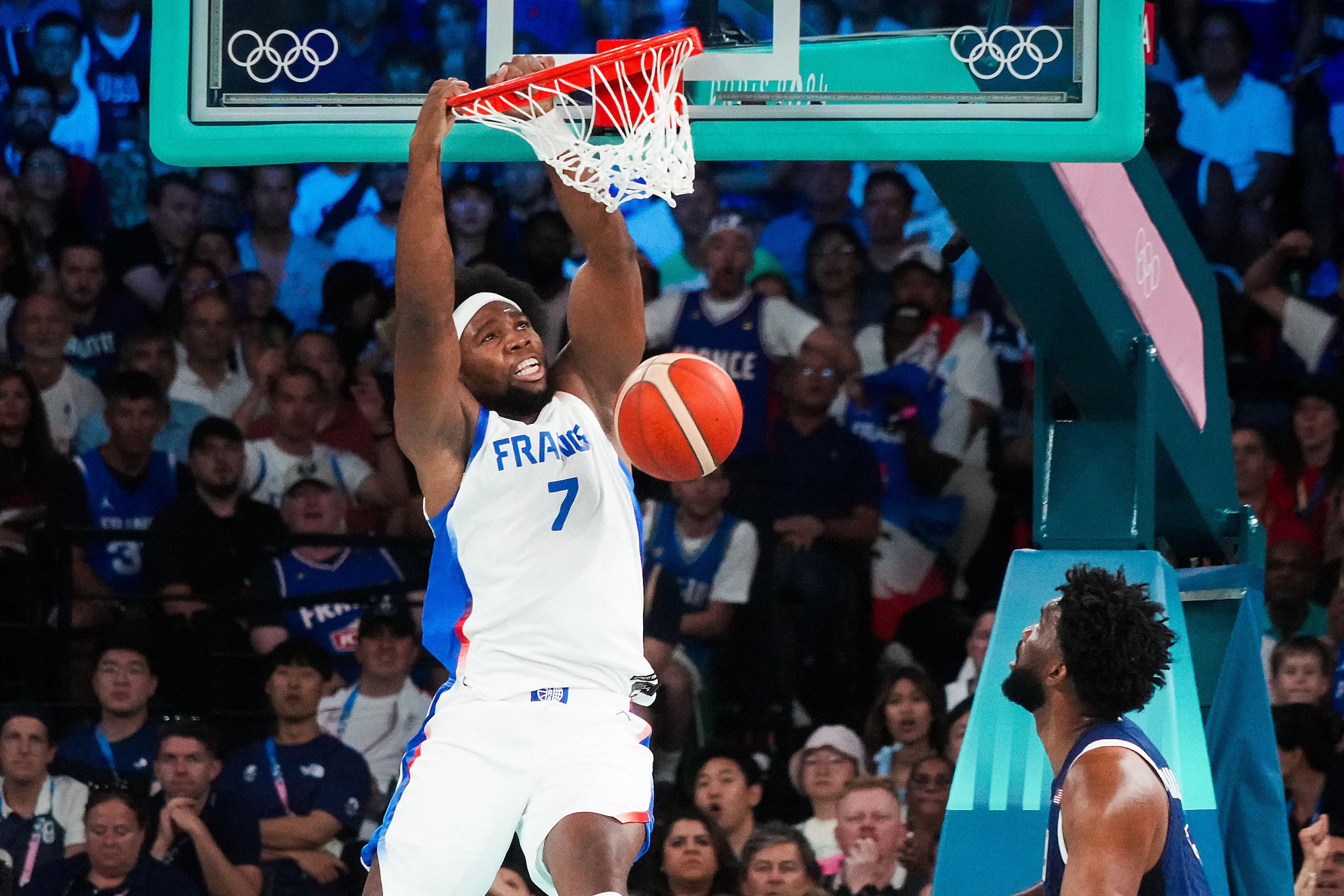 Guerschon Yabusele (7) of France dunks past Joel Embiid (11) of the United States during the...