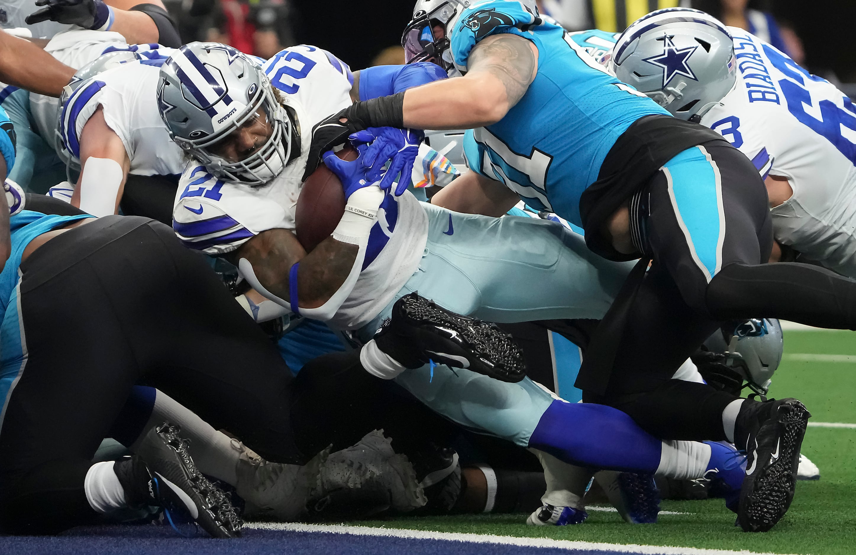 Dallas Cowboys' Micah Parsons (11), Trevon Diggs (7) and Damontae Kazee (18)  celebrate after Diggs made a interception on a pass thrown by Carolina  Panthers' Sam Darnold in the second half of