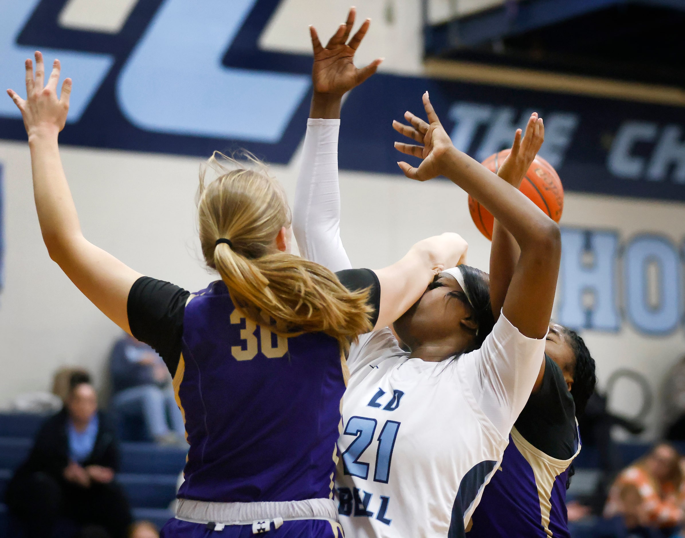 Saginaw Chisholm Trail center Claire Blakley (30) fouls Hurst L.D. Bell forward Gracie Oma...