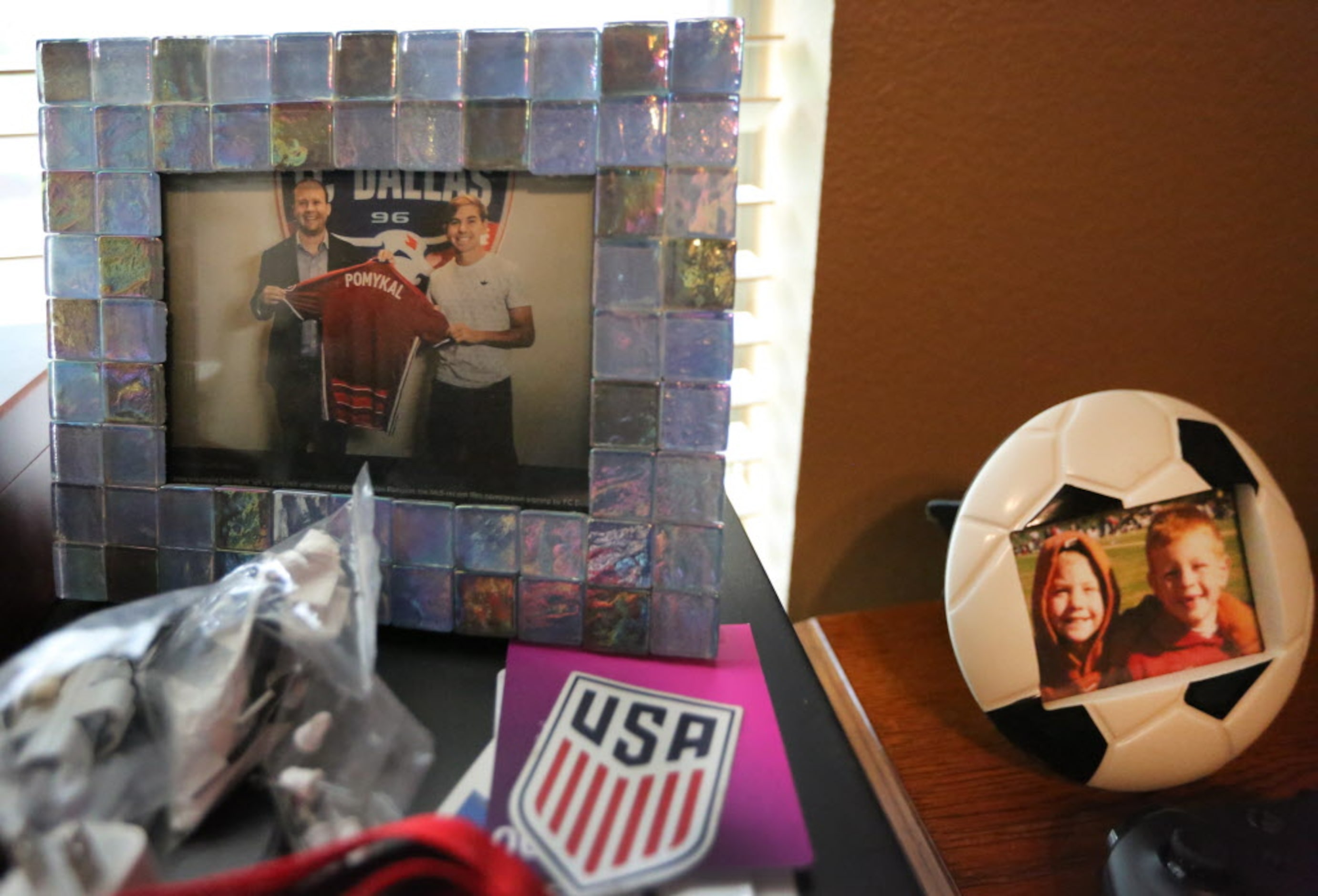 Some of the photographs on display in the bedroom of Paxton Pomykal, a 17-year-old member of...