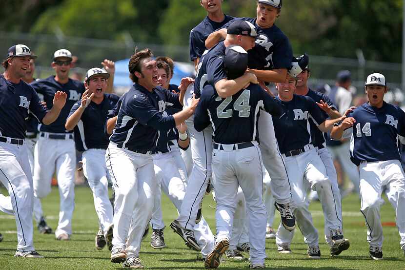 Mobbed by his team mates after the victory, Flower Mound High School's Kyle Johnston (24)...
