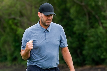 Former Dallas Cowboys quarterback Tony Romo pumps his fist after a putt on the 17th hole...