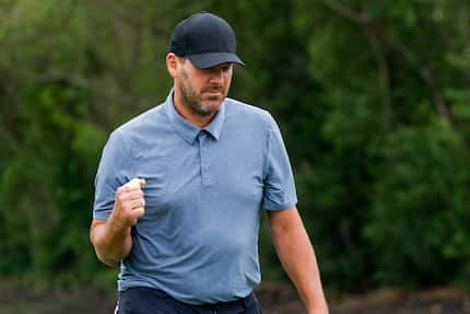 Former Dallas Cowboys quarterback Tony Romo pumps his fist after a putt on the 17th hole...