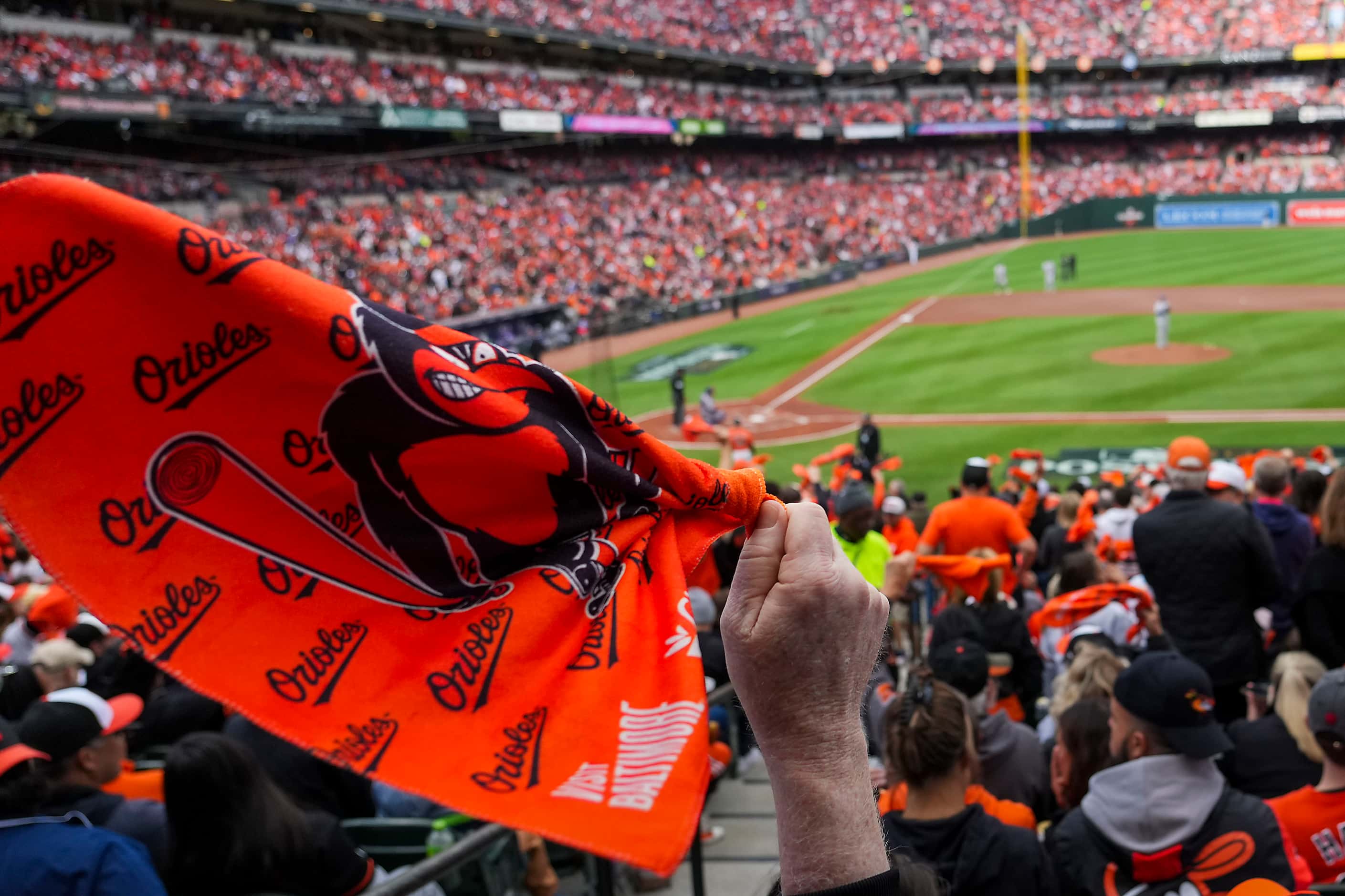 Baltimore Orioles fans wave towels during the first inning in Game 2 of an American League...