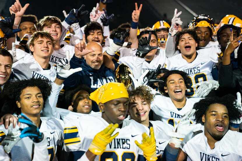 Arlington Lamar players and head coach Laban DeLay celebrate after winning a UIL Class 6A...