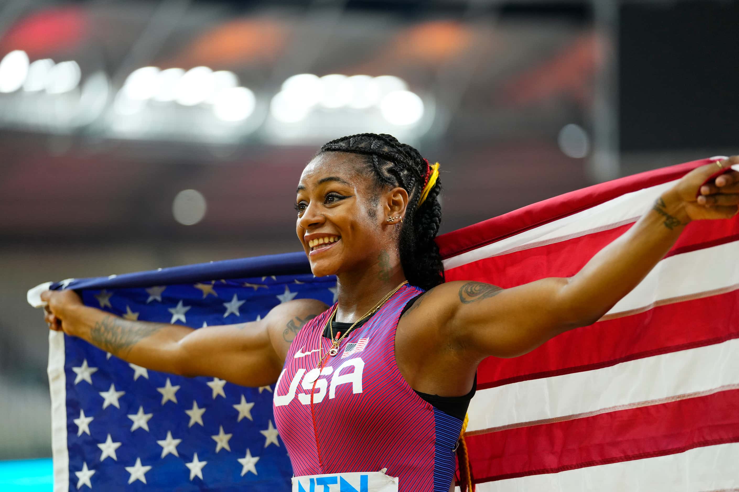Sha'Carri Richardson, of the United States, celebrates after winning the gold medal in the...