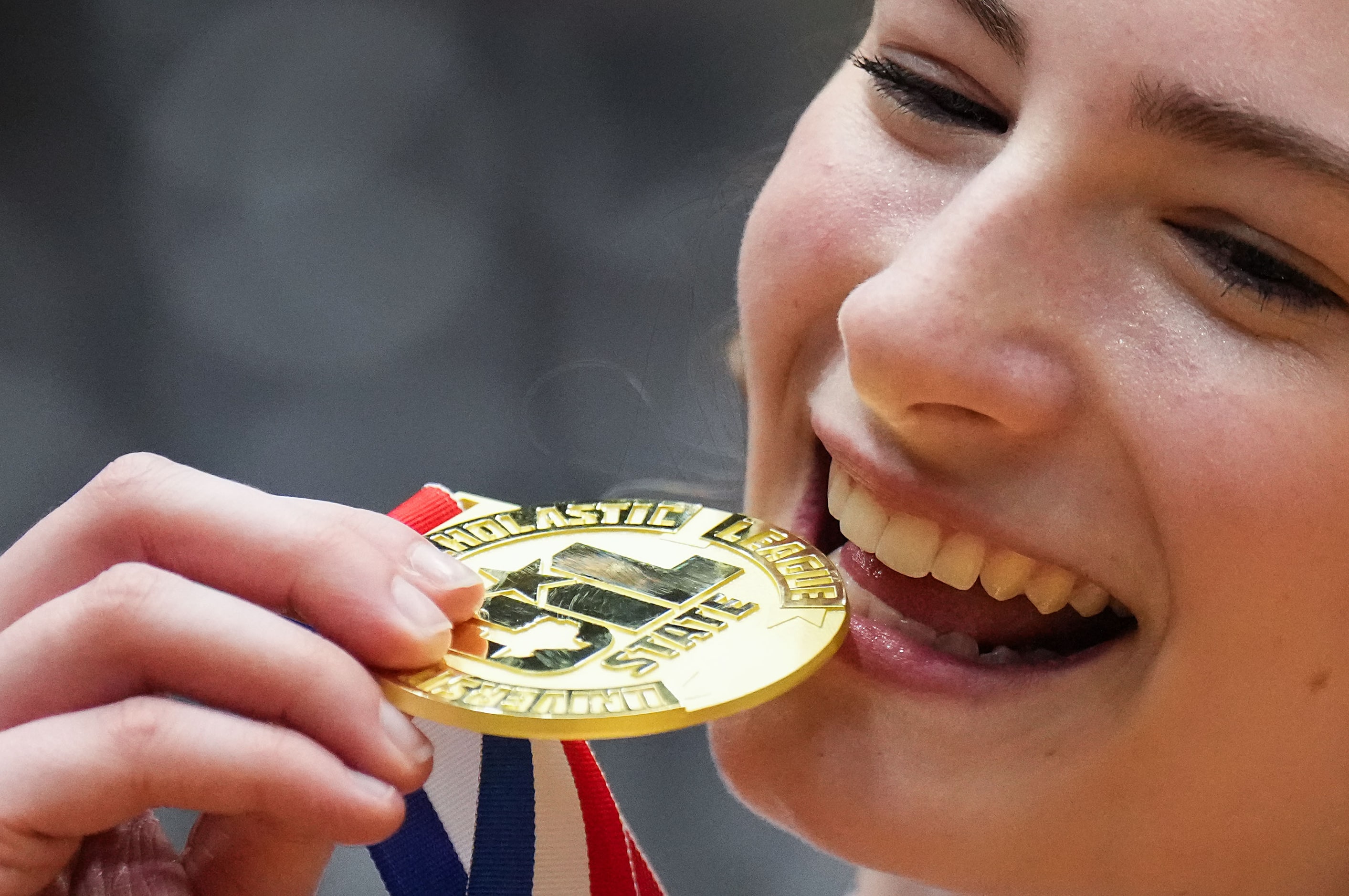 Frisco Wakeland's Hannah Lee shows off her championship medal after a victory over Cedar...