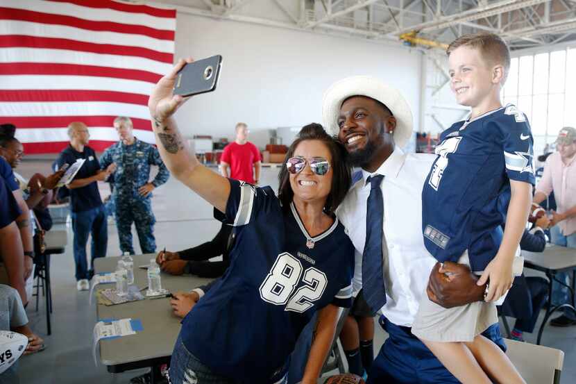 Dallas Cowboys Dez Bryant takes a group photo with Angela Burns and her son Jacob Burns of...