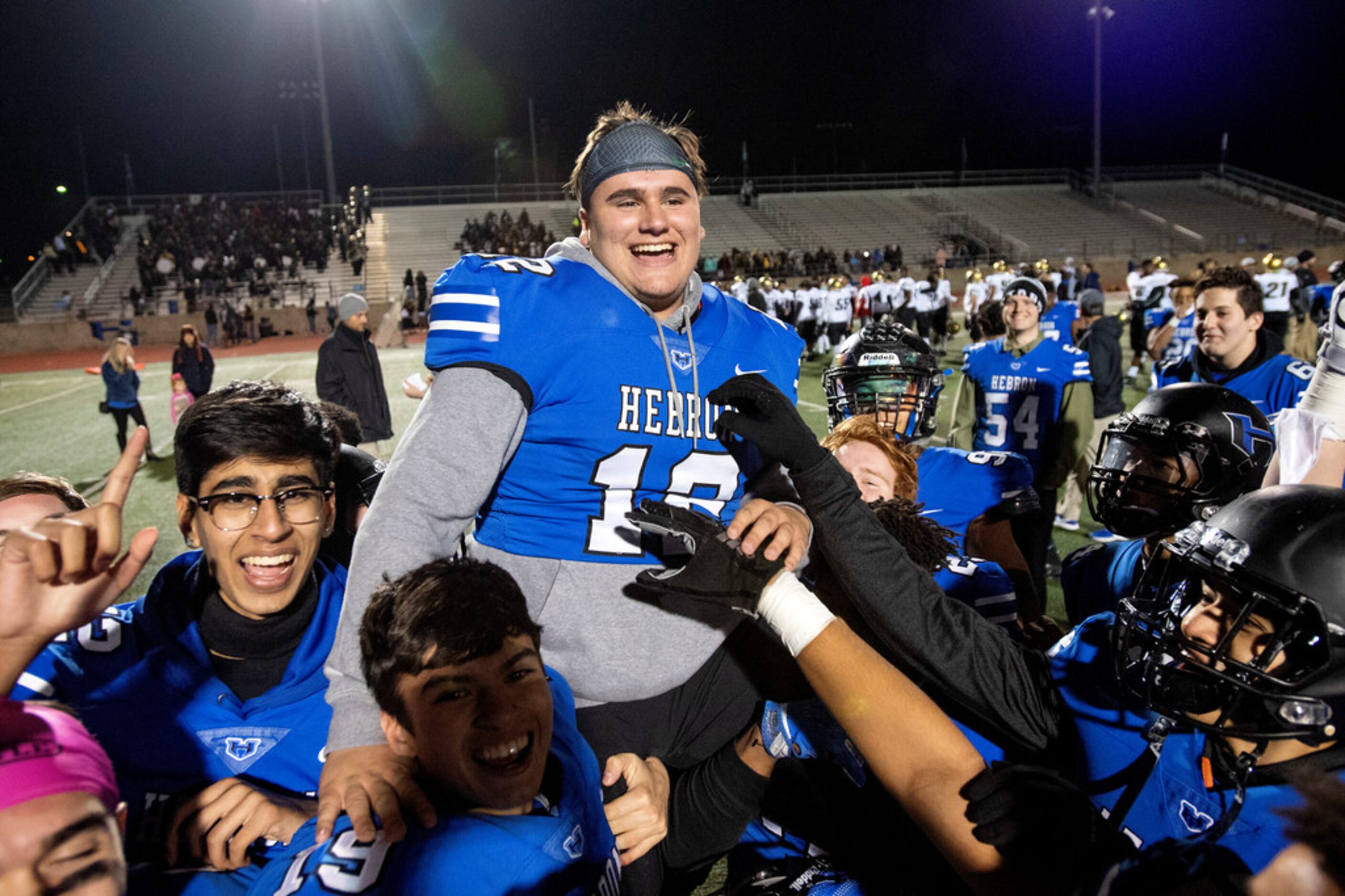 Hebron senior third-string quarterback Tommy Hutchison (12) is hoisted on his teammates'...