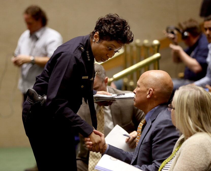 Dallas County District Attorney John Creuzot shakes hands with Dallas Police Chief U. Renee...