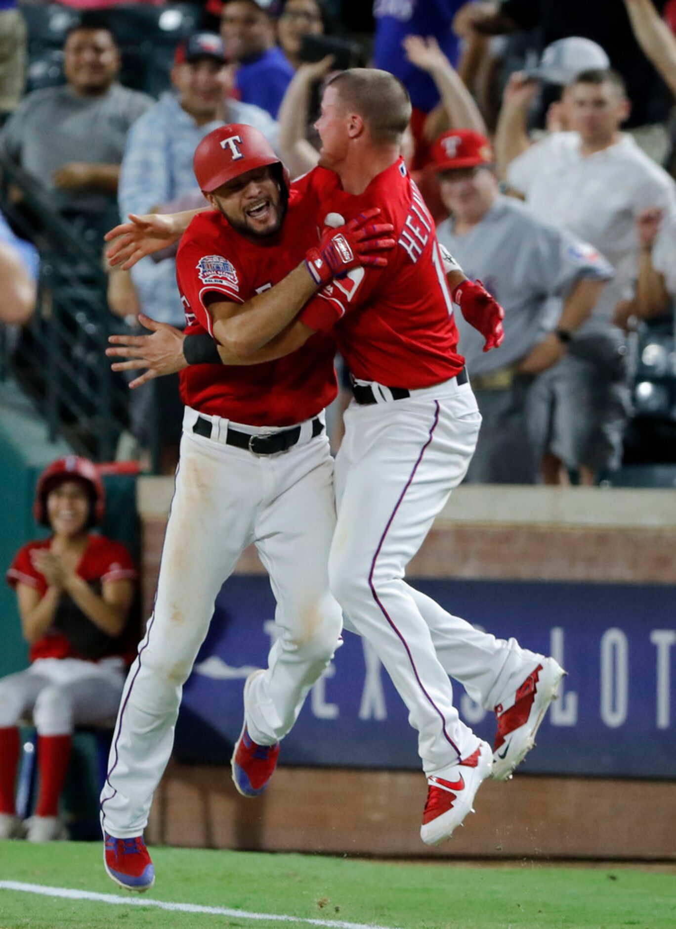 Texas Rangers' Isiah Kiner-Falefa (9) and Scott Heinemann celebrate after Kiner-Falefa hit a...