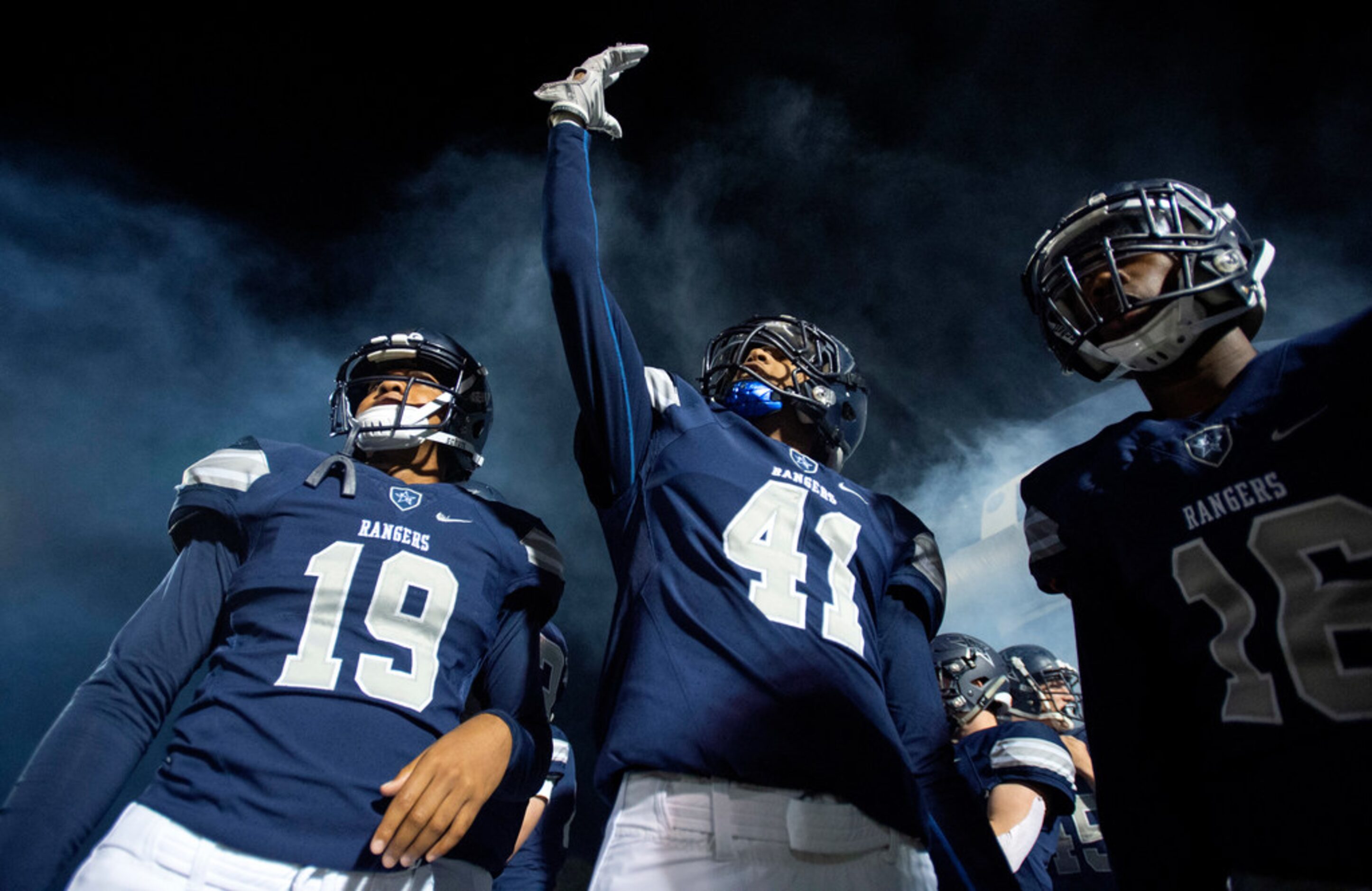 Frisco Lone Star's Landon Whitley (19), Jordan Dupree (41) and Sherman Steptoe (16) get...