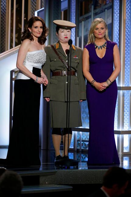 Tiny Fey, from left, Margaret Cho, and Amy Poehler speak at the 72nd Annual Golden Globe...