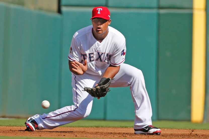 Texas Rangers third baseman Adrian Beltre (29) fields  a grounder by Toronto Blue Jays'...