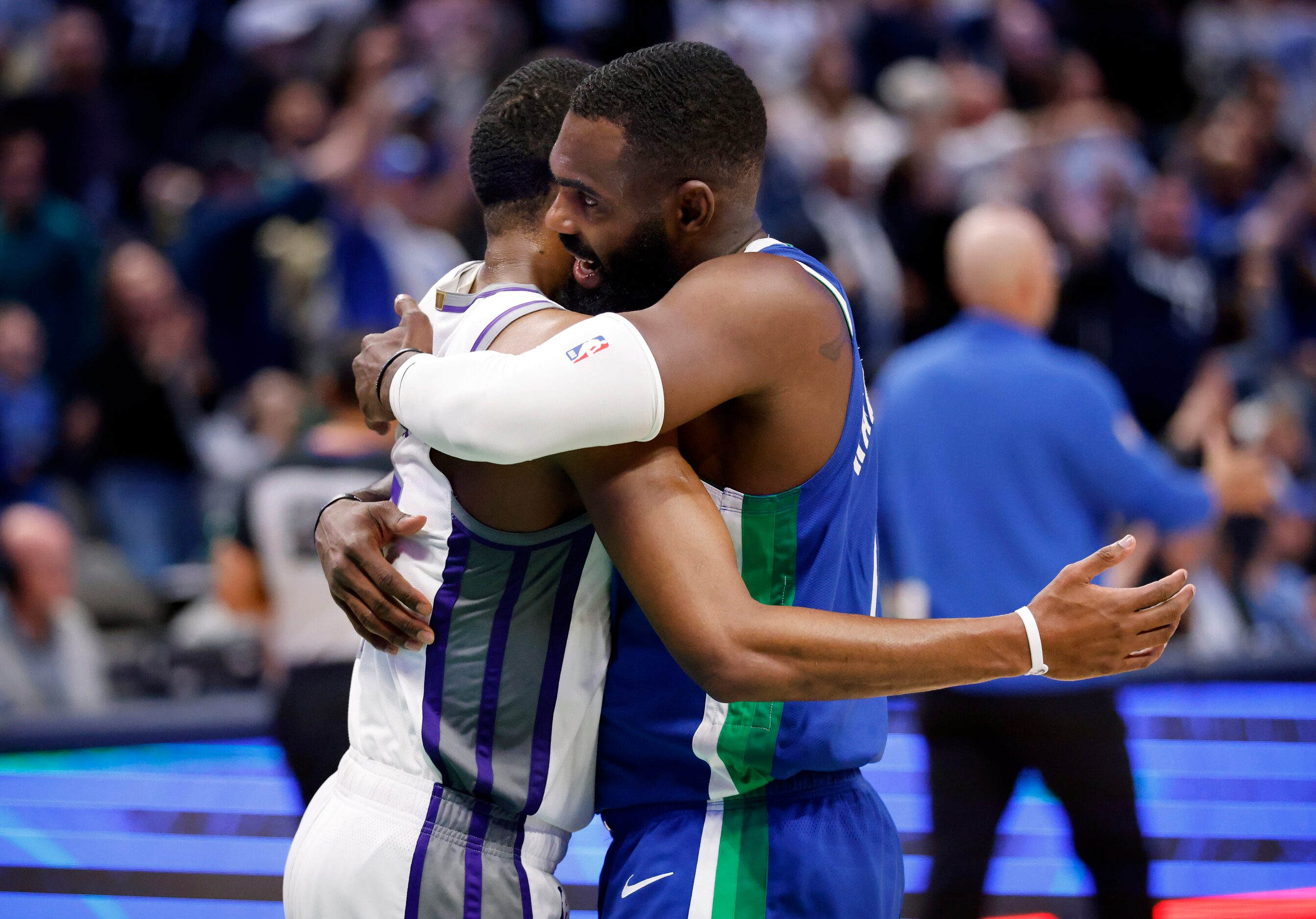 Dallas Mavericks forward Tim Hardaway Jr. (11) hugs Sacramento Kings guard De'Aaron Fox (5)...