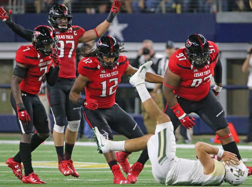 Texas Tech Red Raiders Joseph Wallace (97),  Zach Barnes (12), Jah'Shawn Johnson (7) and...