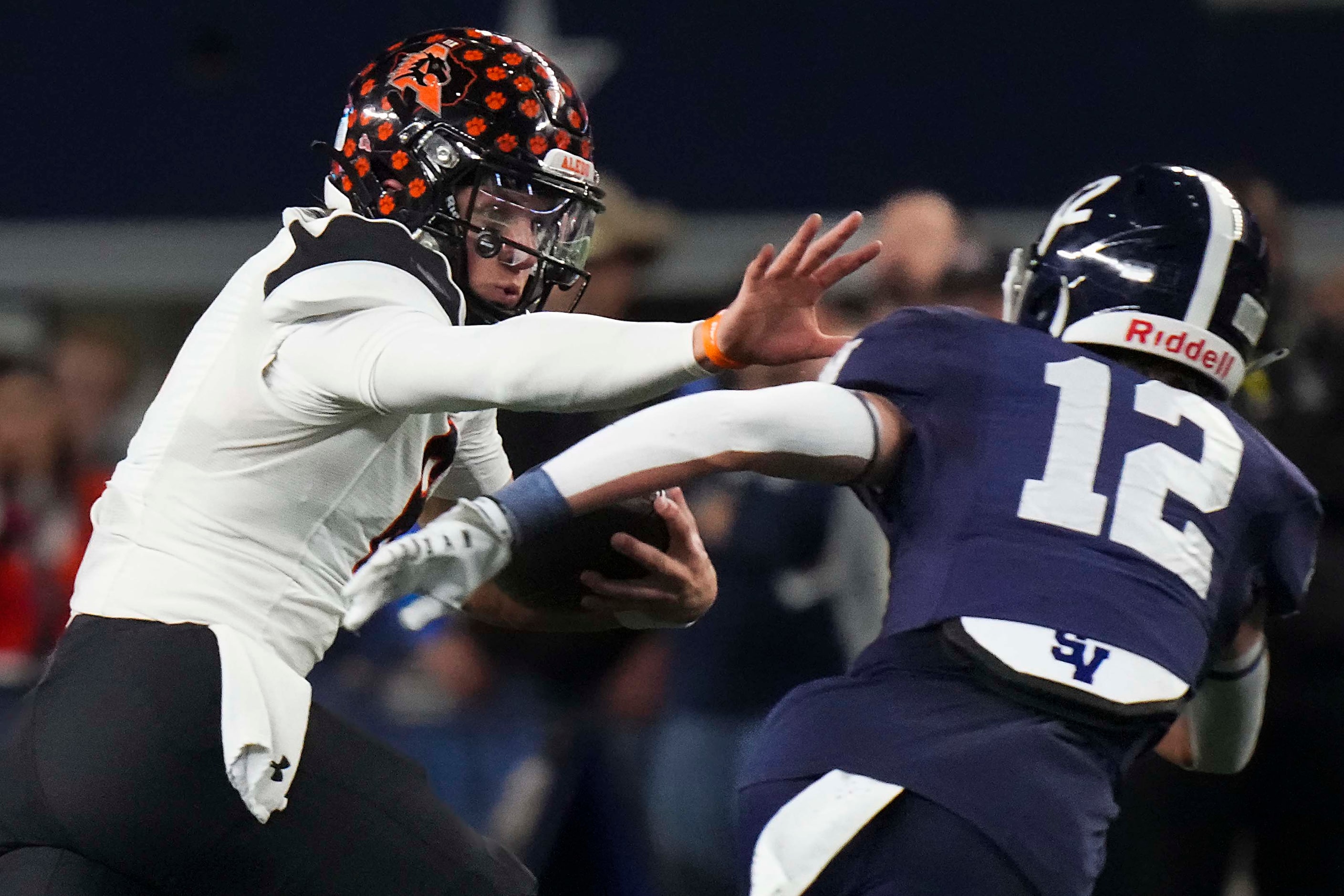 Aledo quarterback Hauss Hejny (8) reaches out to stiff arm Comal Smithson Valley defensive...