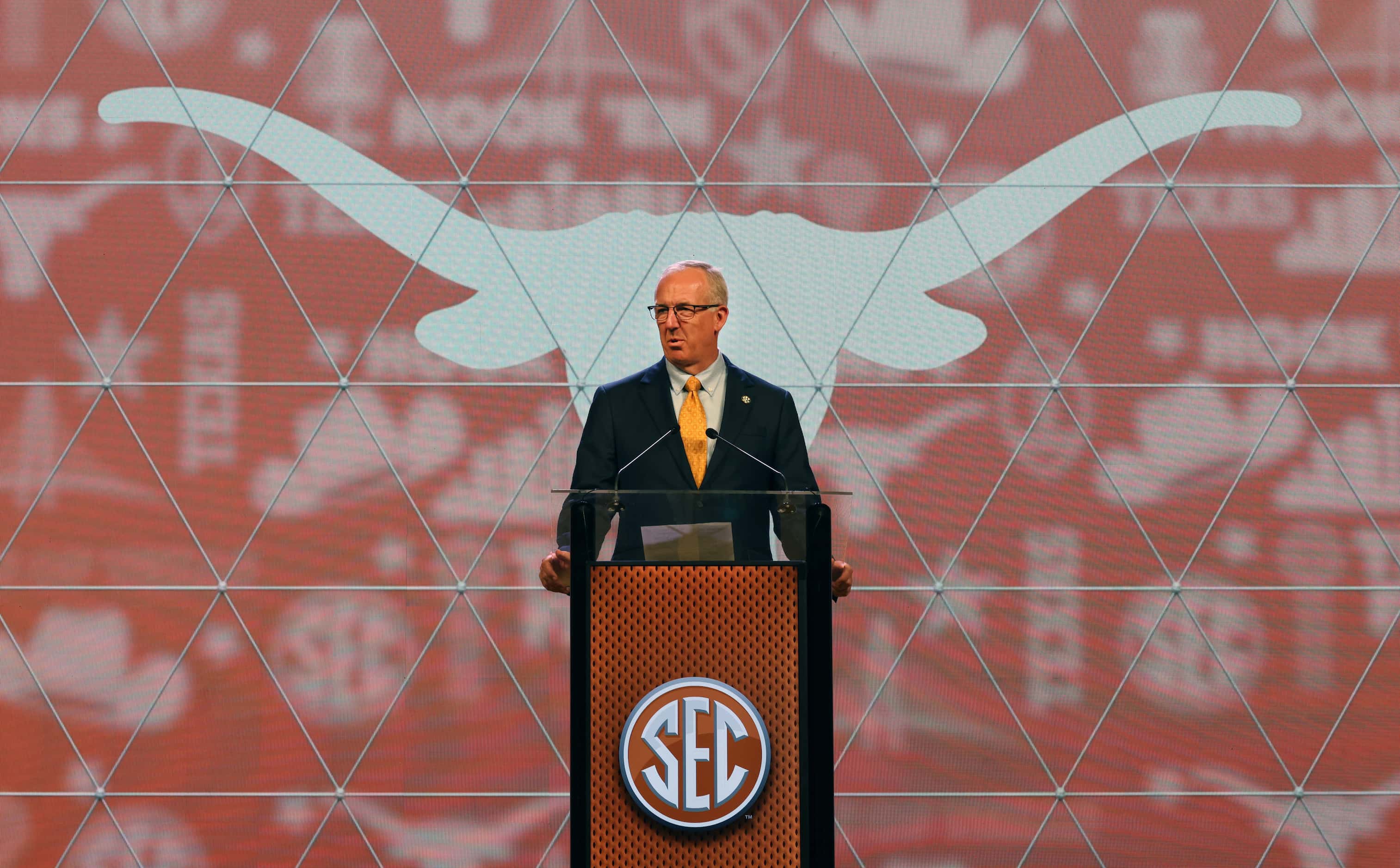 South Eastern Conference commissioner Greg Sankey stands in front of the team logo as he...