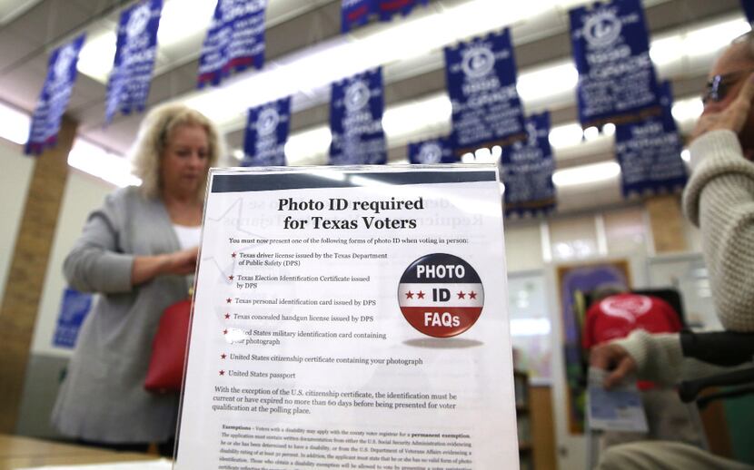  In this 2016 file photo, a sign tells voters of voter ID requirements before participating...
