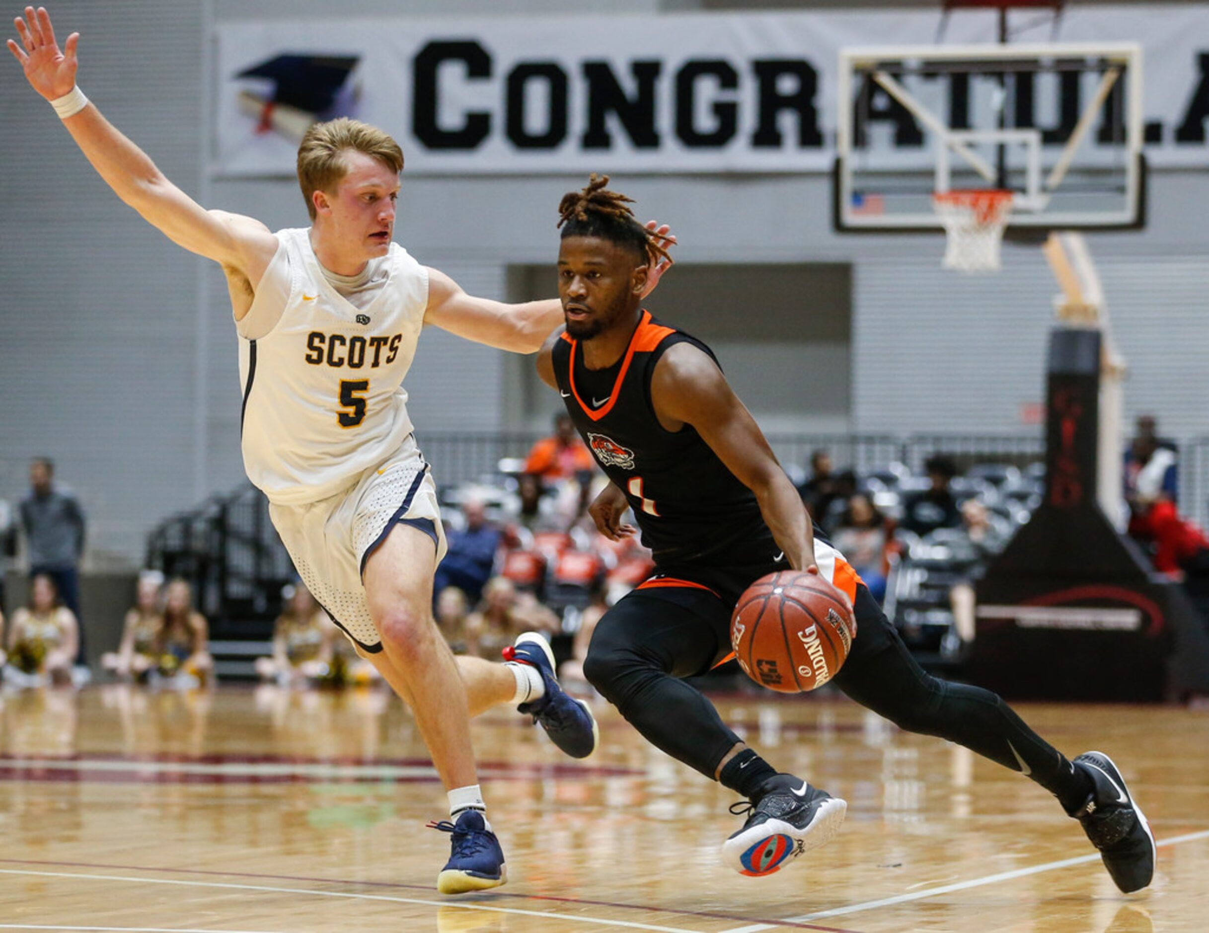 Lancaster's Mike Miles (1) drives past Highland Park's Drew Scott (5) during the first half...