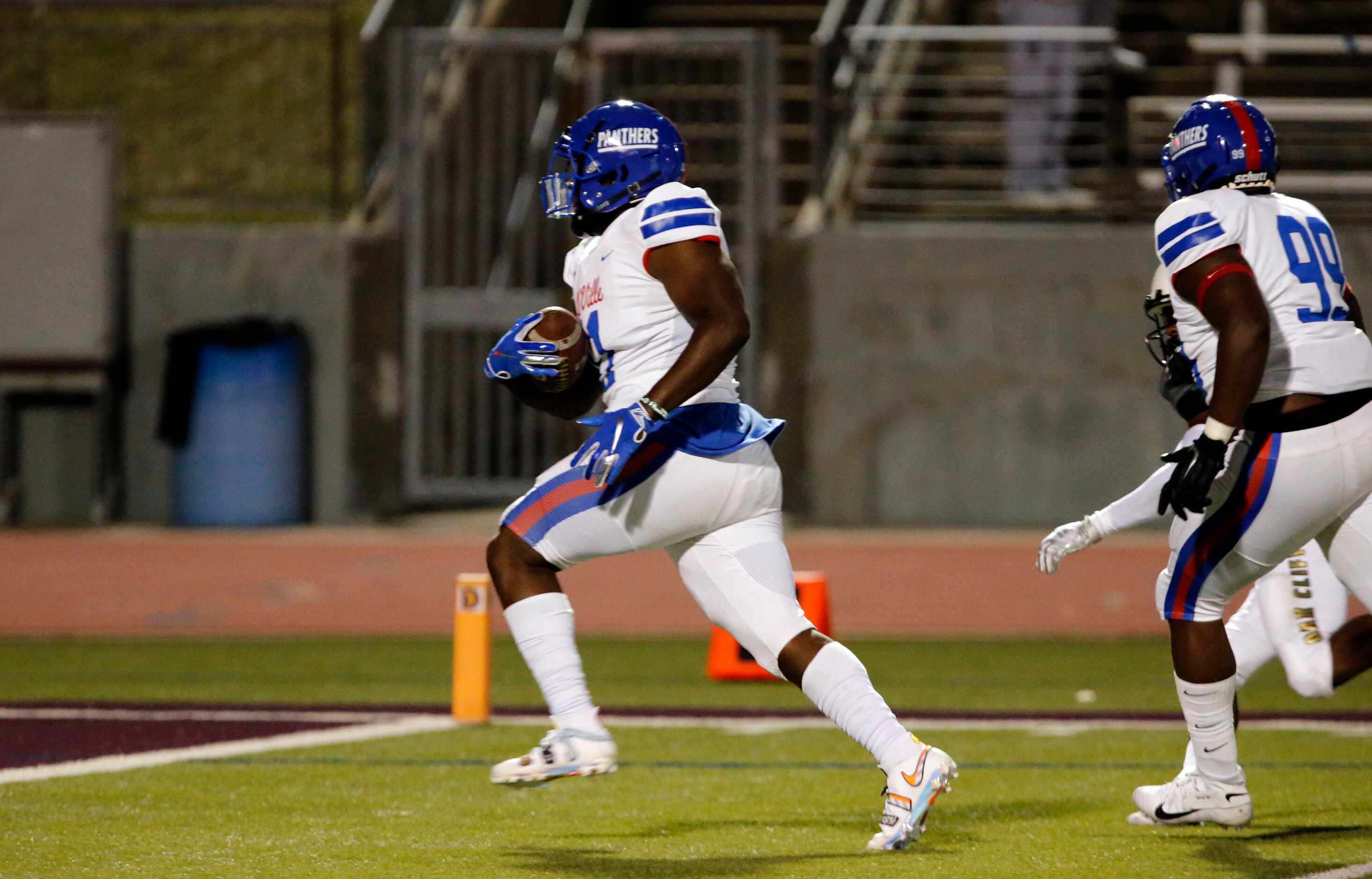 Duncanville’s Tyler Quinn (11) takes a interception to the end zone for a touchdown during...
