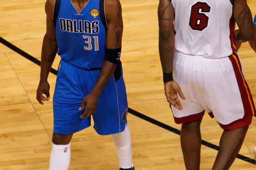 Dallas Mavericks shooting guard Jason Terry (31) eyes Miami Heat small forward LeBron James...