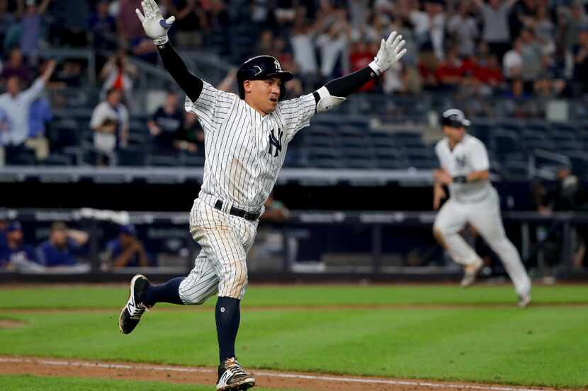 New York Yankees' Ronald Torreyes gestures as he runs to first on the game-winning RBI...