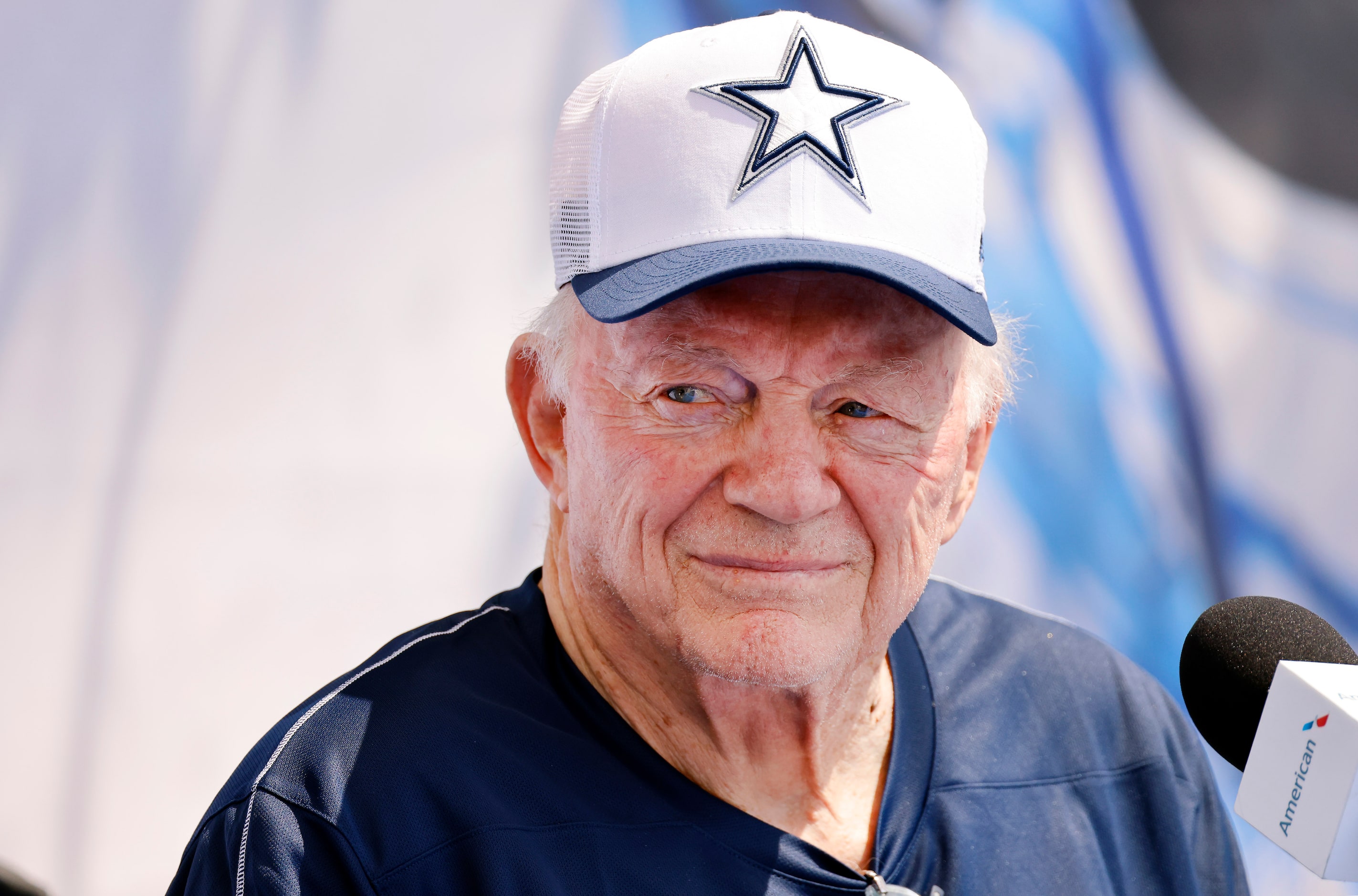 Dallas Cowboys owner Jerry Jones listens to his head coach speak during the opening press...