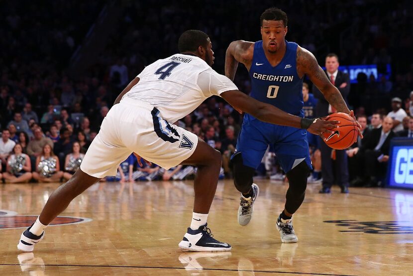 NEW YORK, NY - MARCH 11:  Eric Paschall #4 of the Villanova Wildcats defends against Marcus...