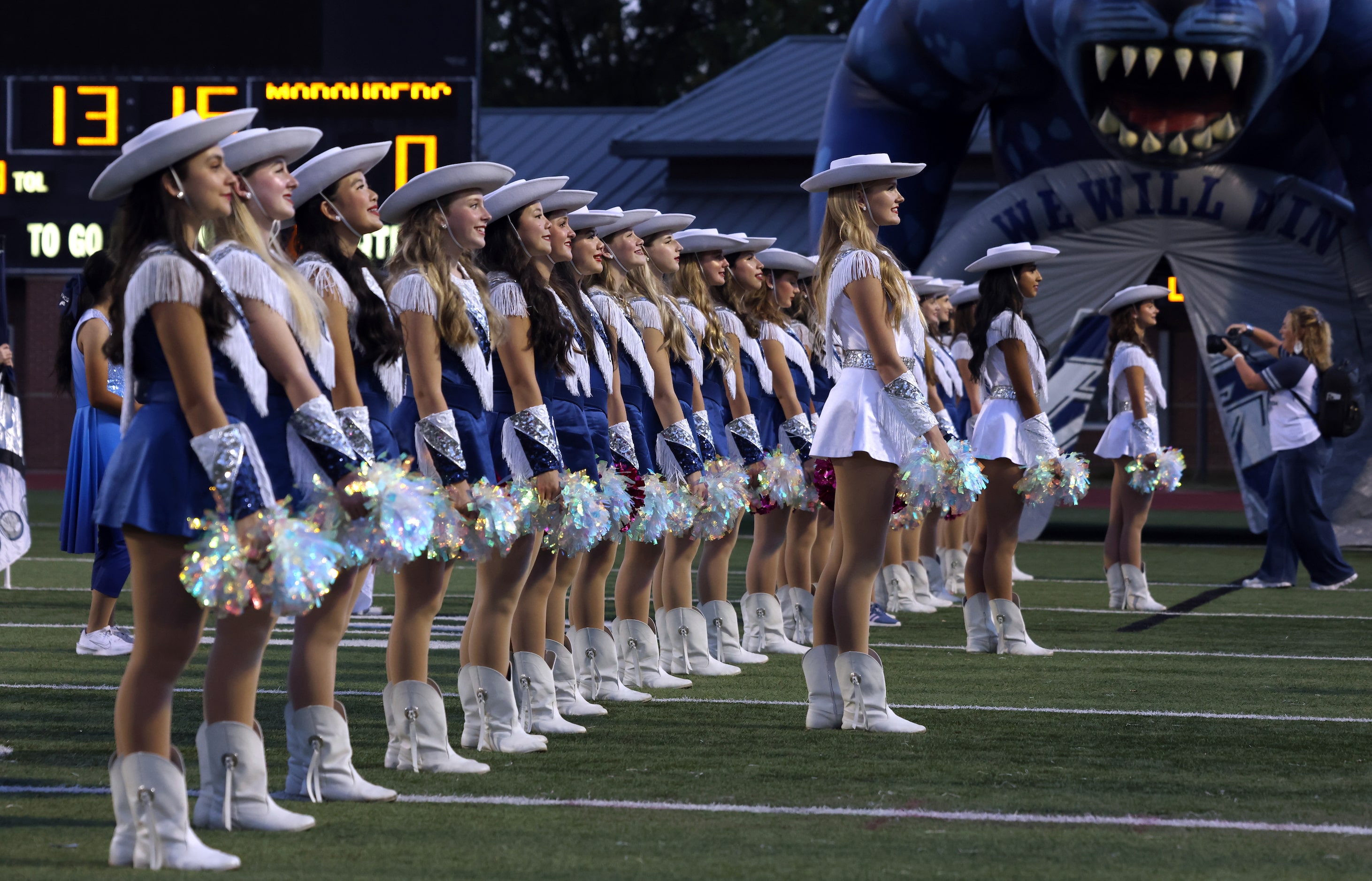 Flower Mound drill team members await the arrival of Jaguars players to the field for team...