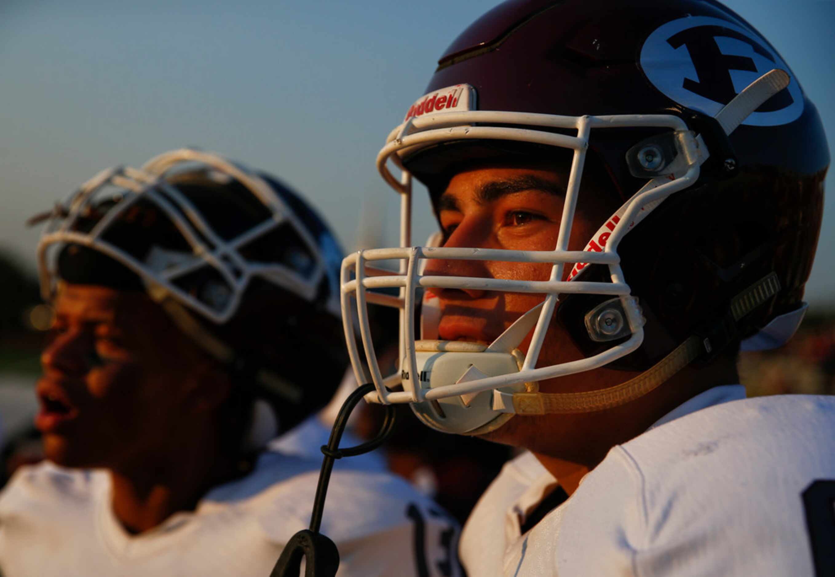 Ennis players watch from the sideline during a high school football game between Bishop...