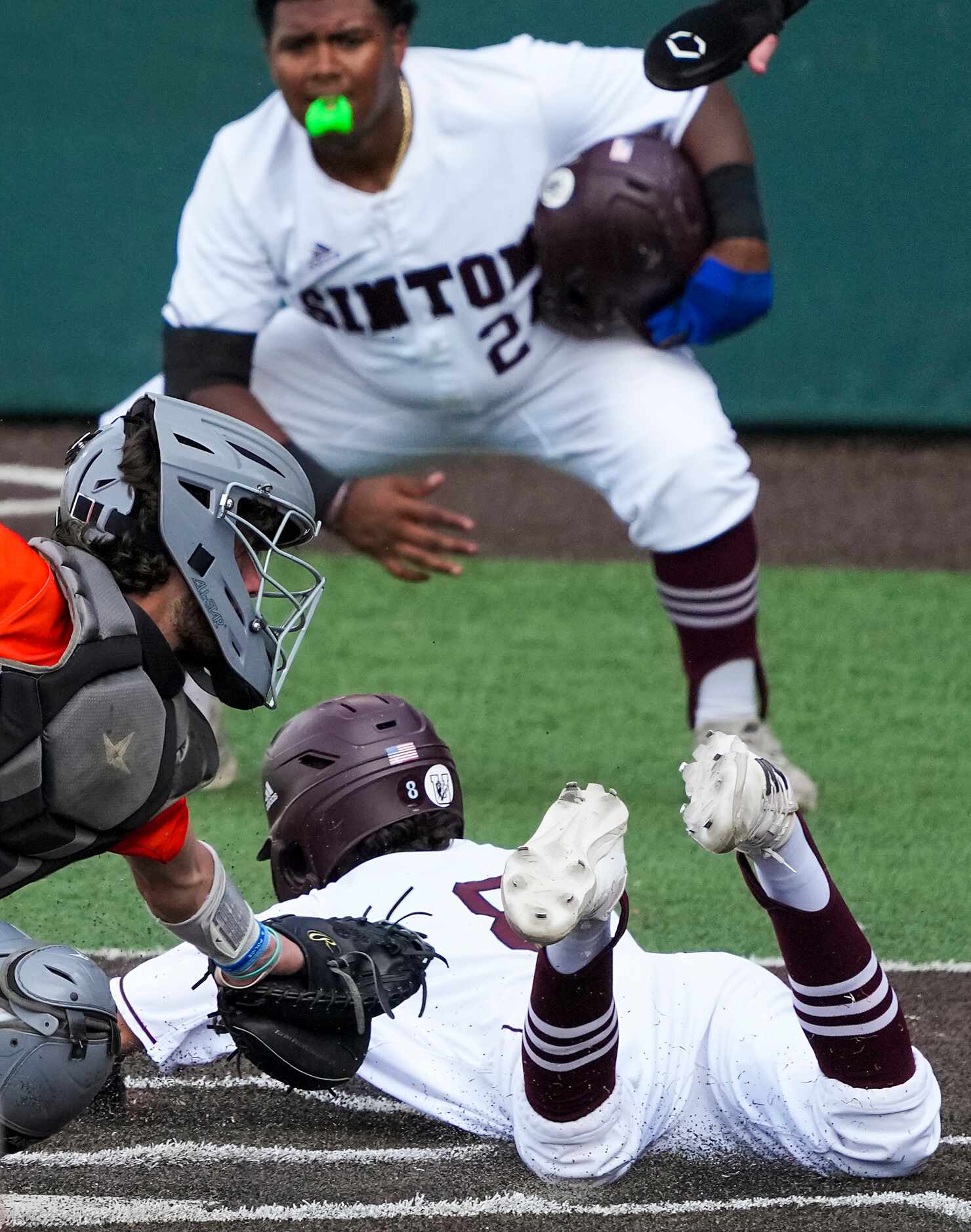 Sinton second baseman Marco Gonzales (8) scores past Celina catcher Ty Marthiljohni (5)...