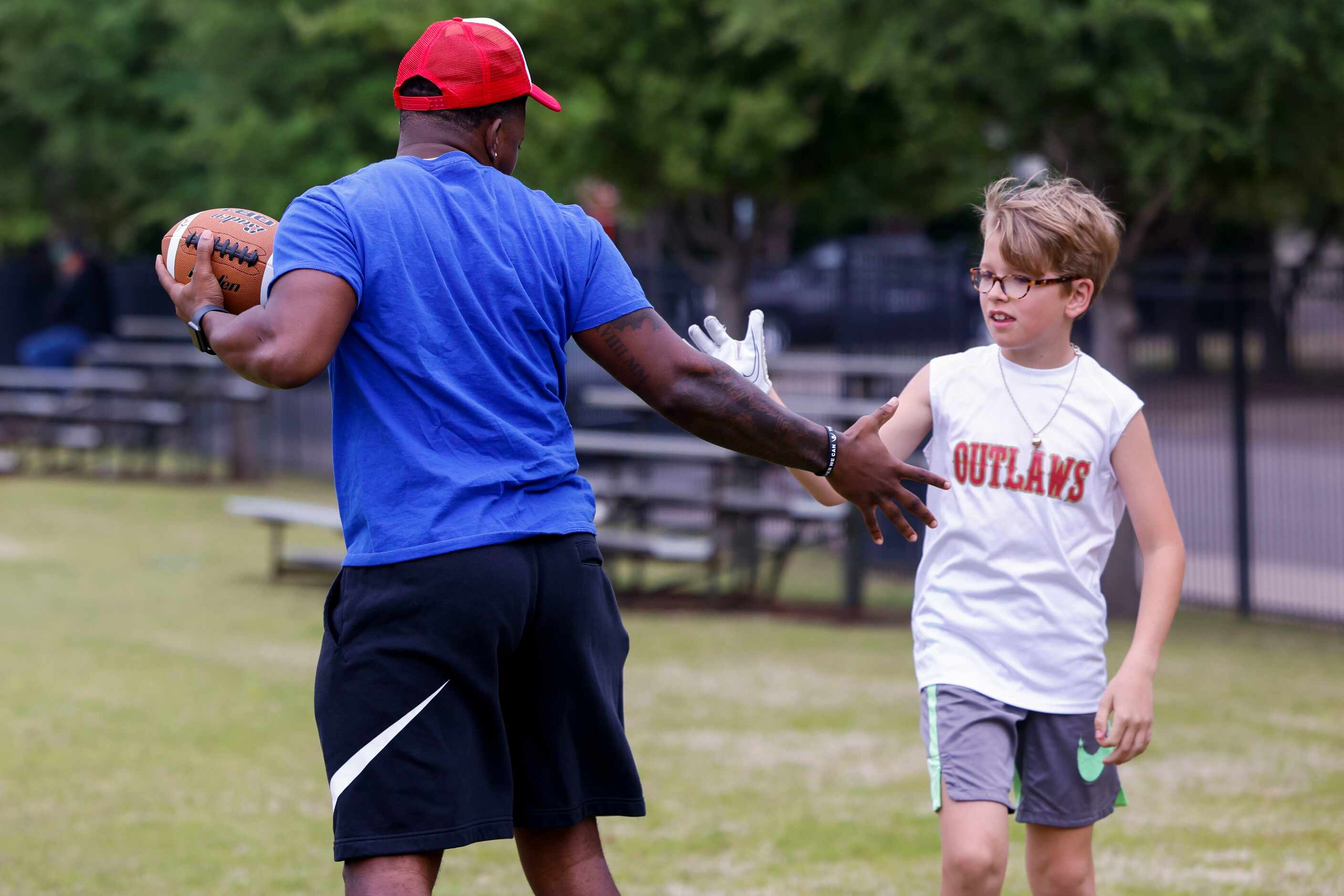 SMU’s Kam Farrar (left) high fives Chris Crump during a special session of football drills...
