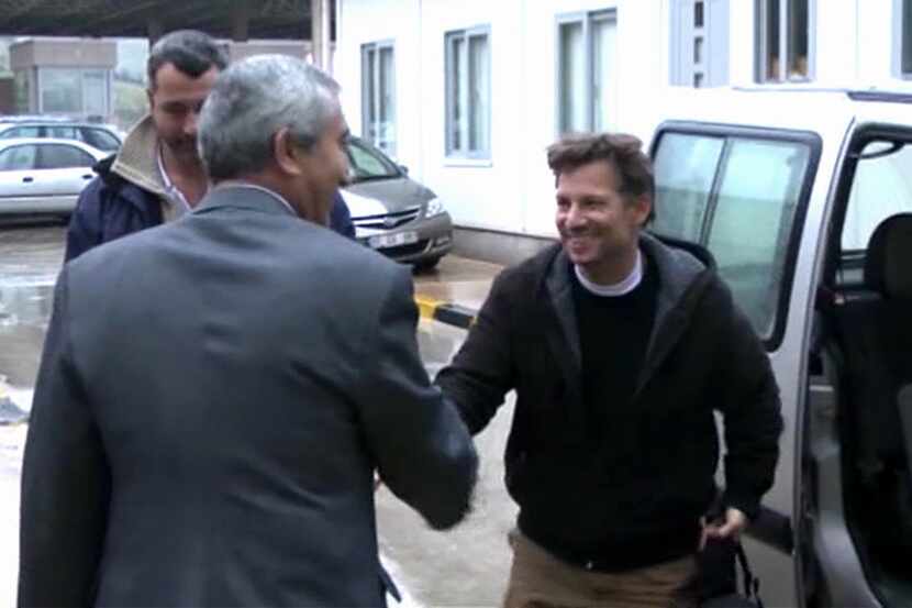 In this image made from video, NBC chief foreign correspondent Richard Engel, right, shakes...