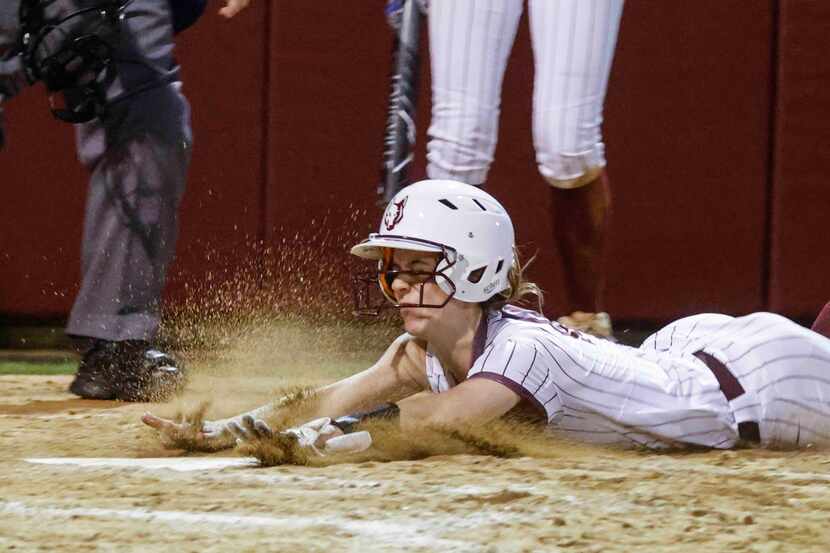 Frisco Heritage's Jaicee Stott scores a run in the fifth inning during Friday's 11-7 victory...