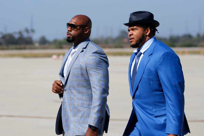 Dallas Cowboys offensive tackle Tyron Smith and La'el Collins make their way to the hangar...