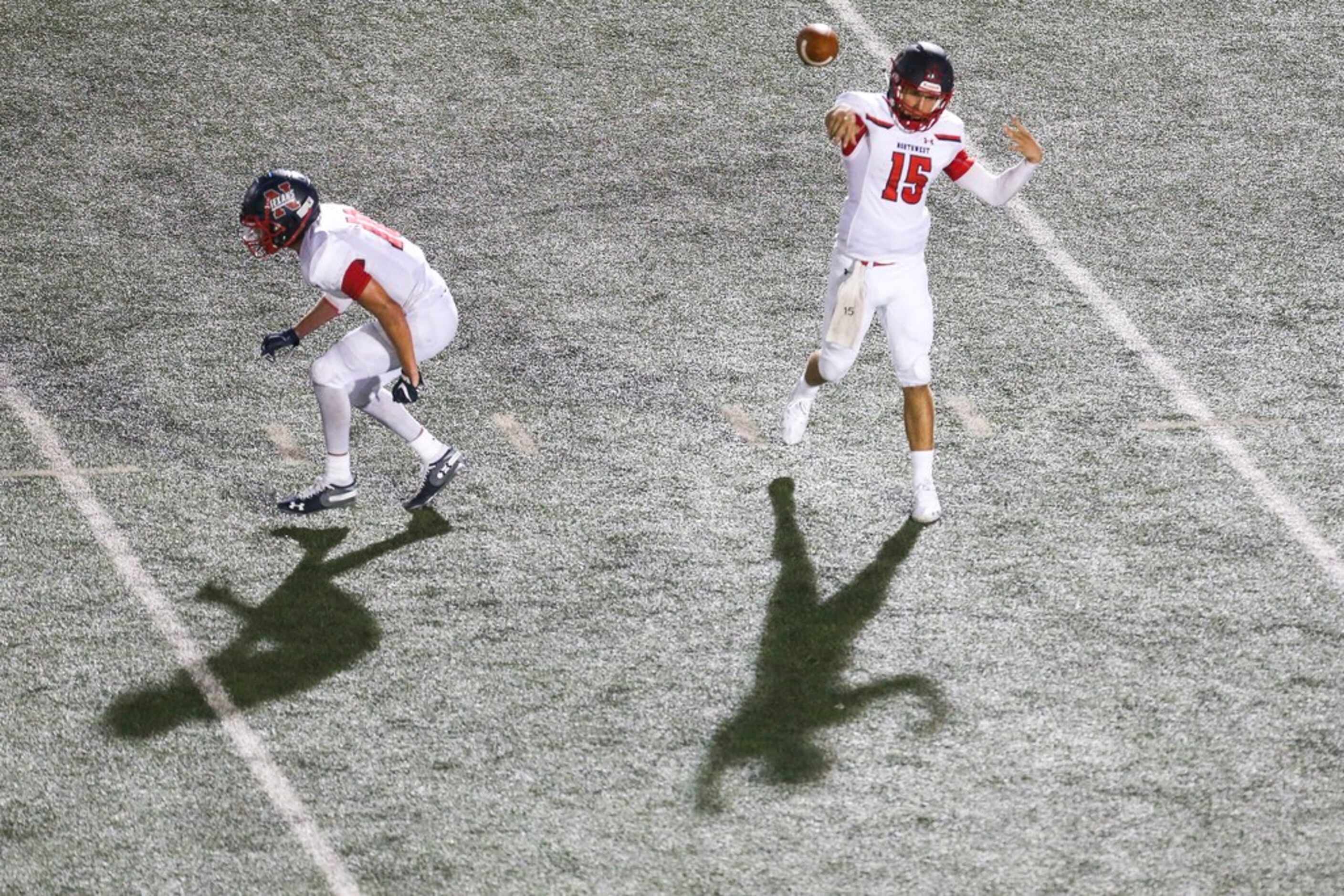 Northwest quarterback Austin Ahmad (15) makes a pass as running back Kyndel Sims protects...