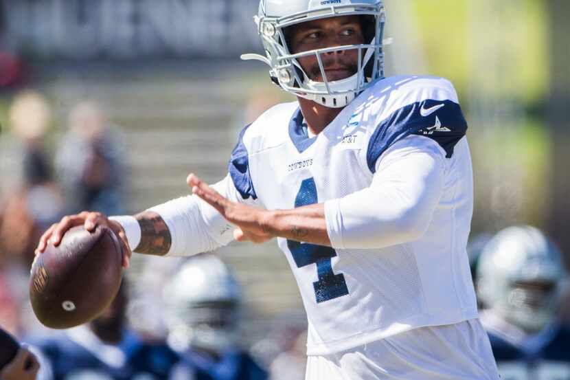 Dallas Cowboys quarterback Dak Prescott (4) throws a pass during an afternoon practice at...