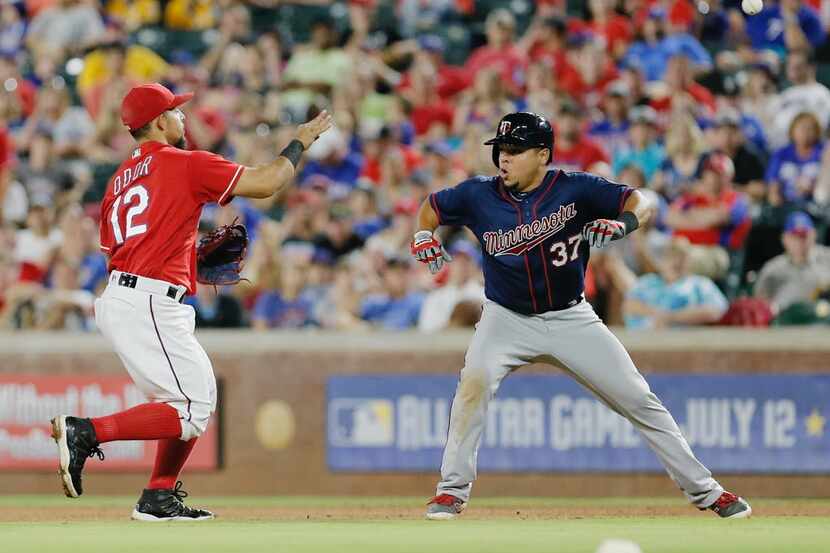 Texas Rangers second baseman Rougned Odor (12) throws to first for the out on Minnesota...
