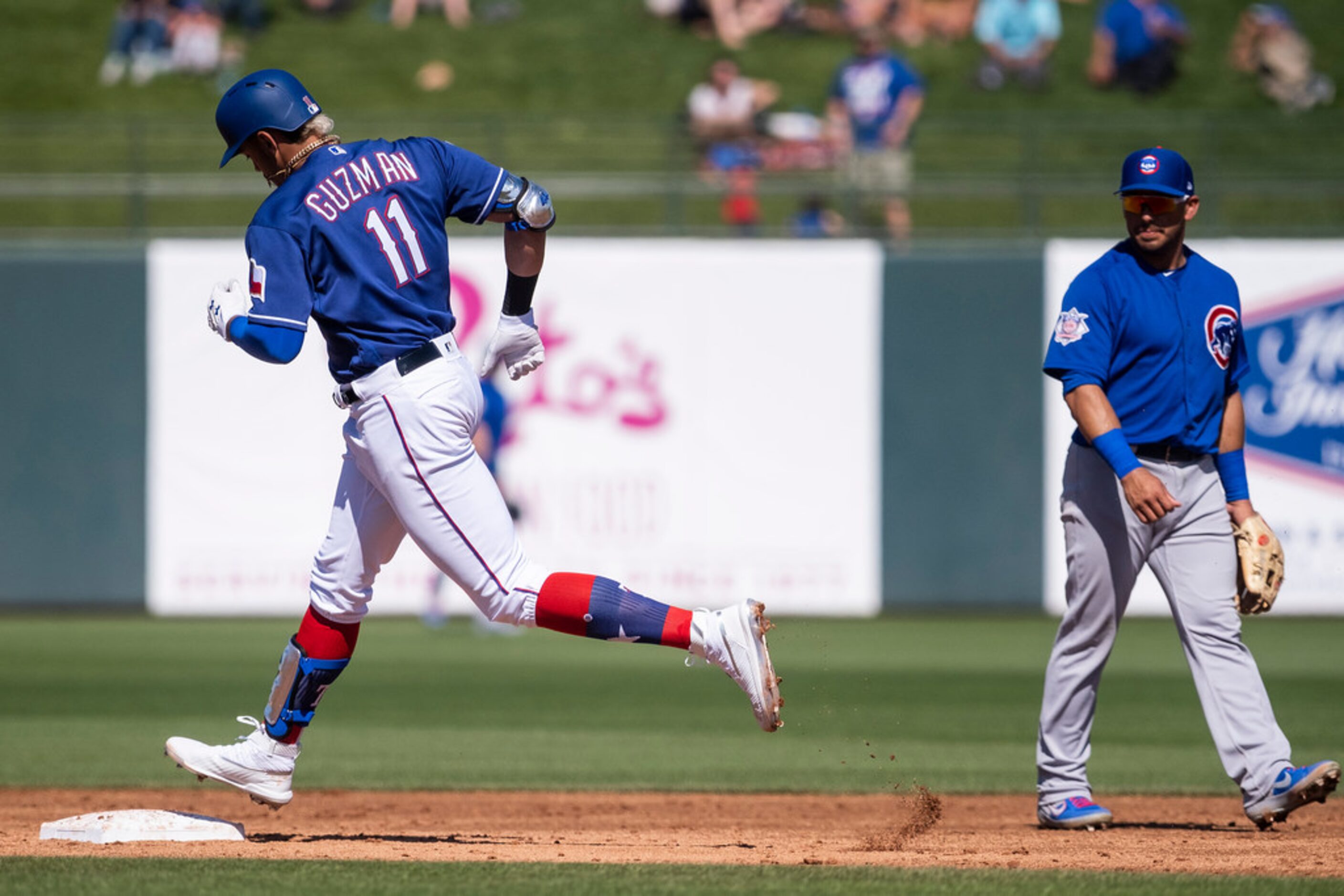 Texas Rangers first baseman Ronald Guzmâ¡n rounds the bases after hitting a solo home run...