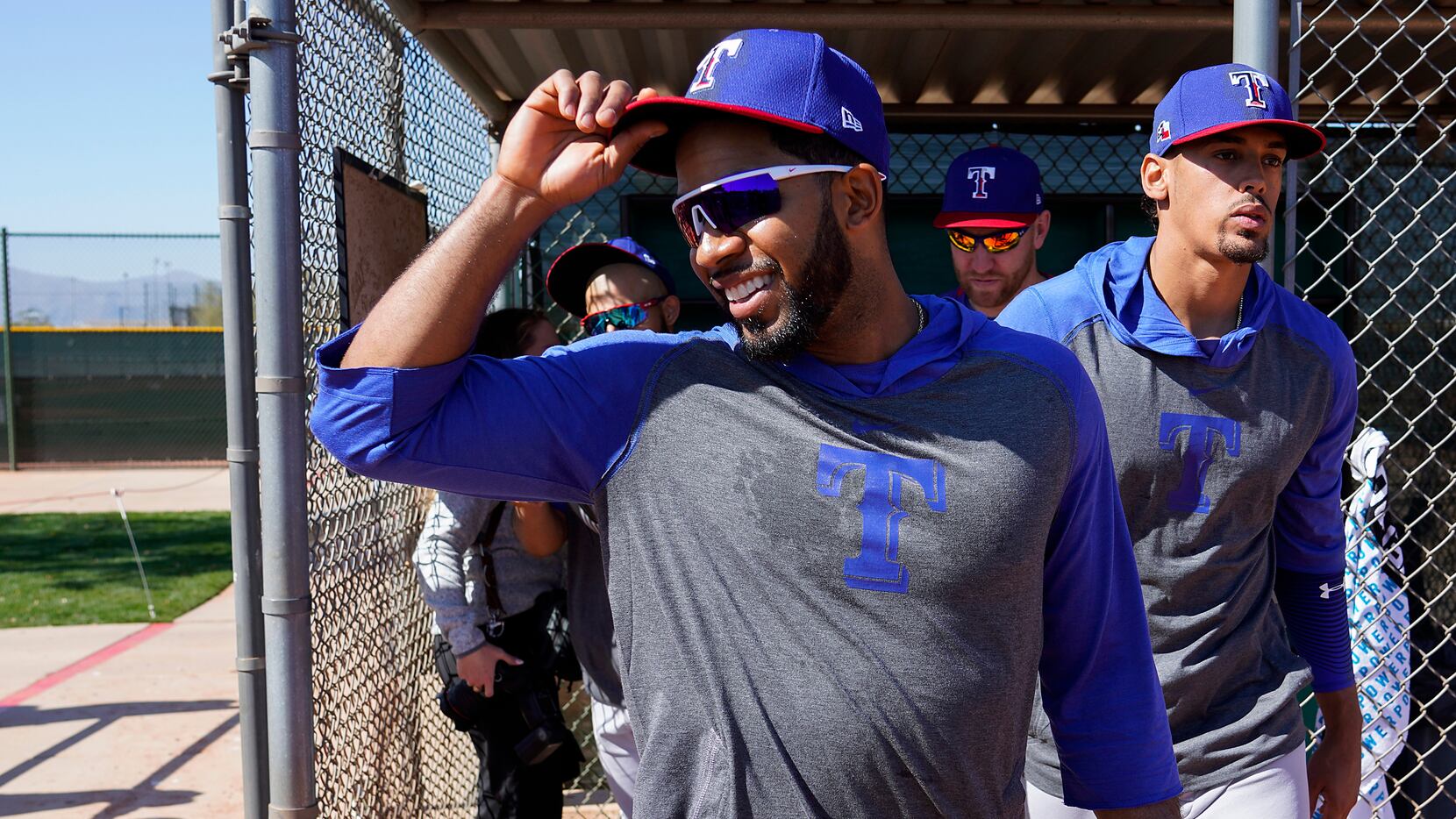 Texas Rangers shortstop Elvis Andrus tips his cap as he walks from a dugout on to a practice...