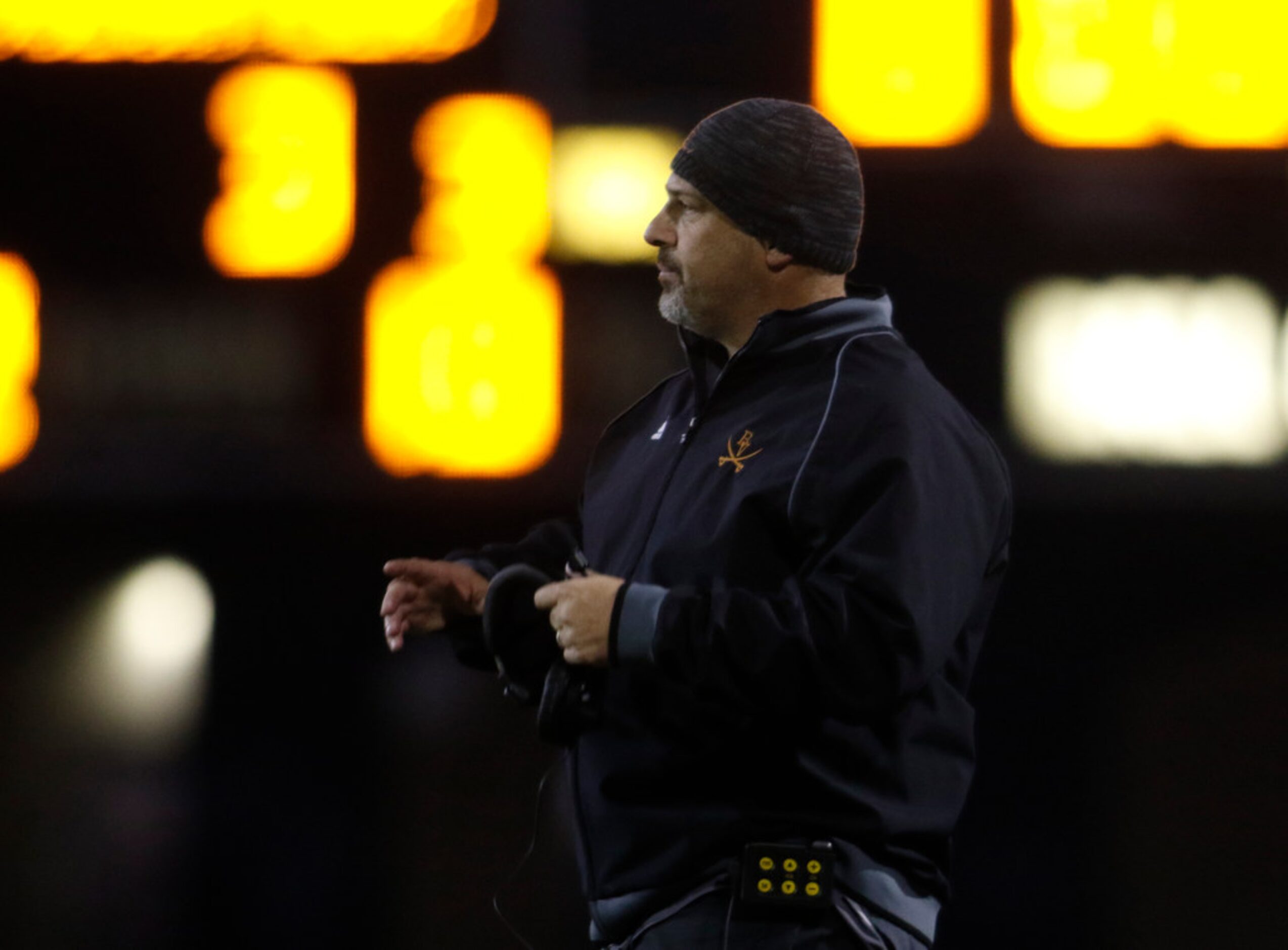 Arlington Bowie head coach Danny DeArman follows 2nd quarter action from the team bench area...