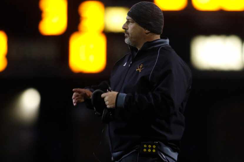 Arlington Bowie football coach Danny DeArman follows the action during a game against...