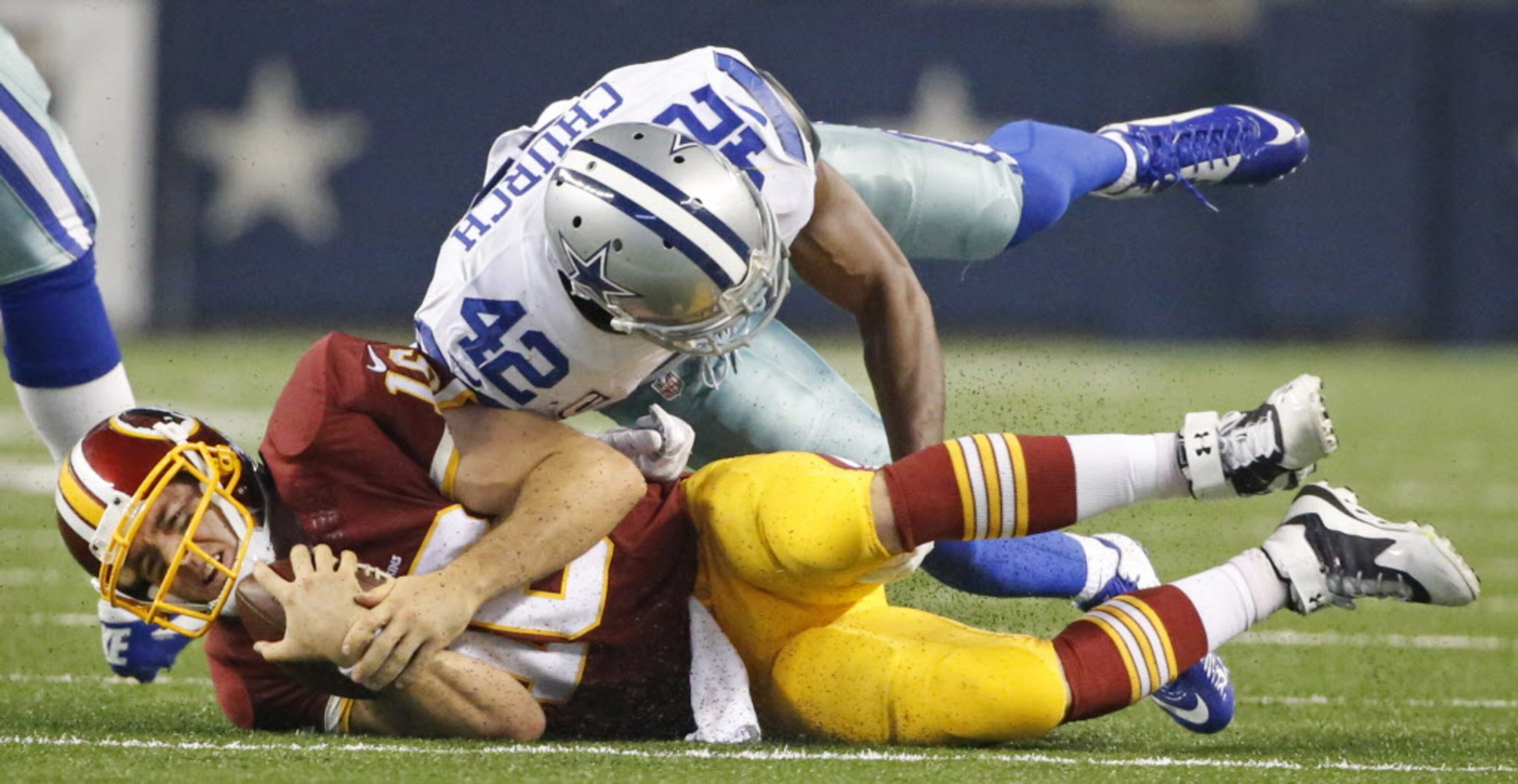 Washington Redskins quarterback Colt McCoy (16) is stopped by Dallas Cowboys free safety...