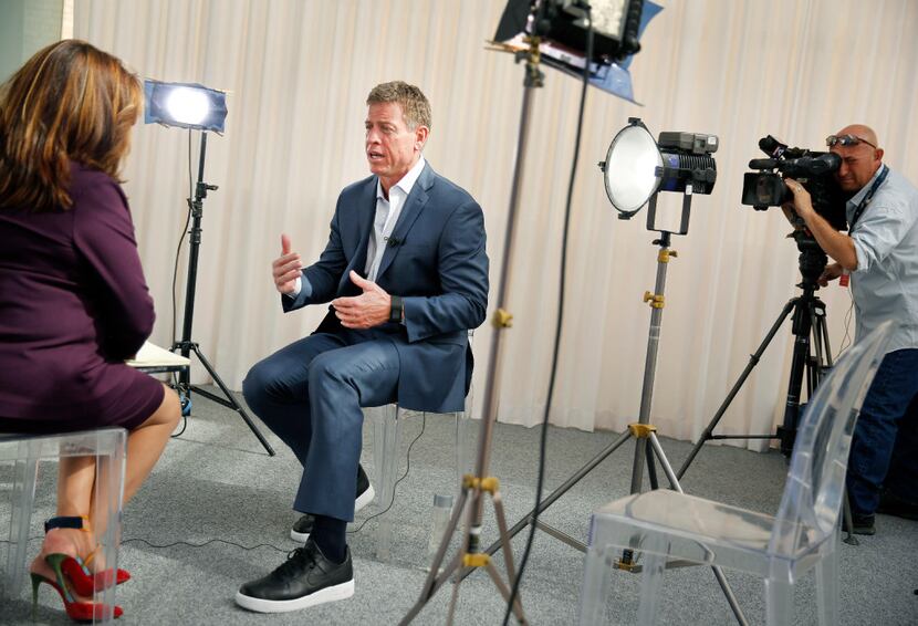 Hall of Fame Dallas Cowboys quarterback Troy Aikman (center) sits down with FOX 4 anchor...
