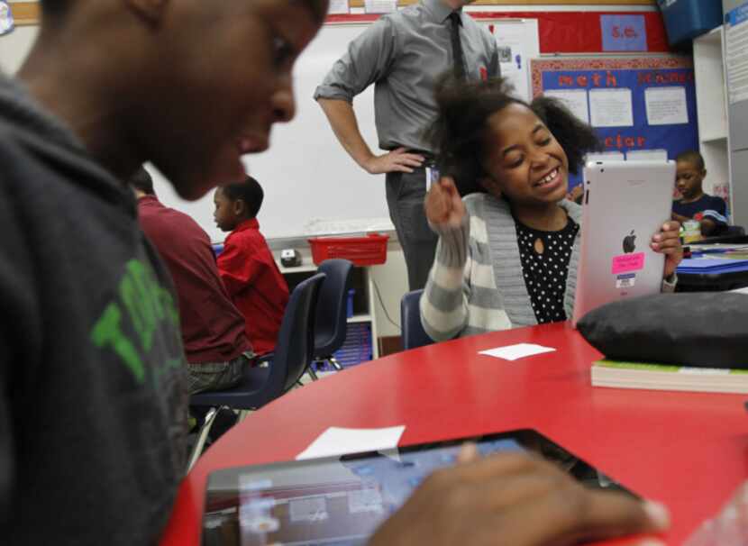 Braxton Brown (left) and Zaria Peace checked out the fourth grade’s new iPads at Rutherford...