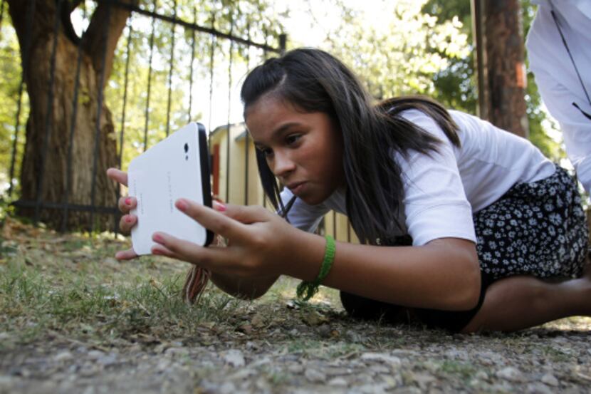 Sasha Roppolo, 13, of Richardson used a tablet to take photos that showed missing sidewalks...
